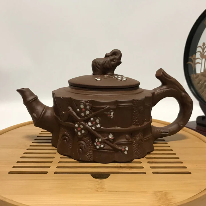 Clay teapot with bamboo body, plum blossom and an elephant lid finial