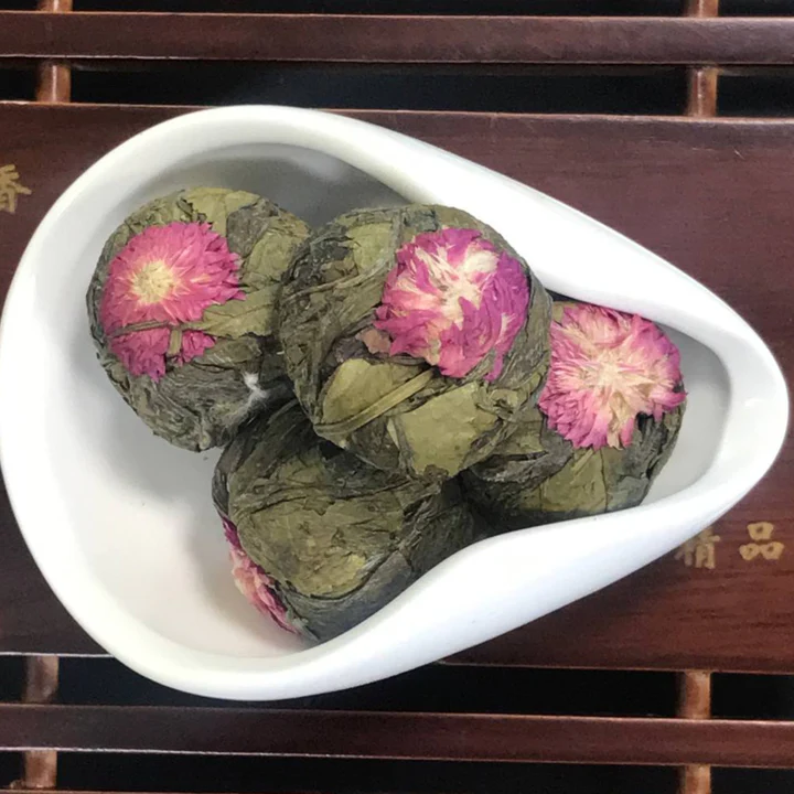 Green blooming tea balls topped with yellow chrysanthemum
